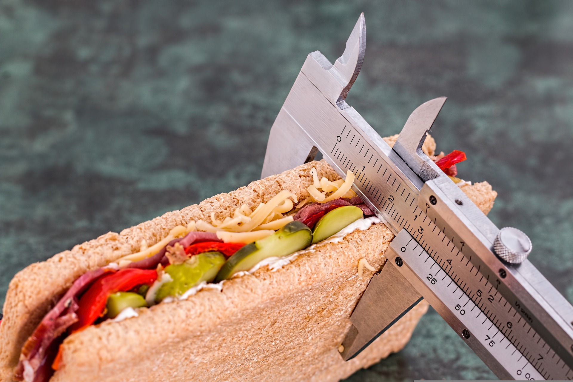 a vernier caliper measuring a sandwich