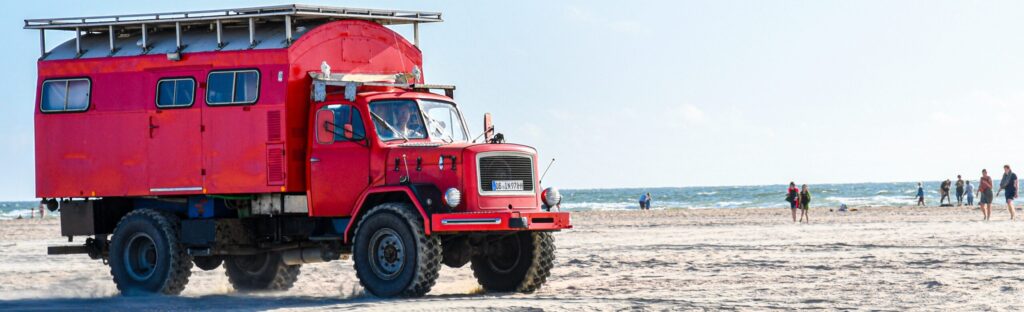 Red truck on the beach
