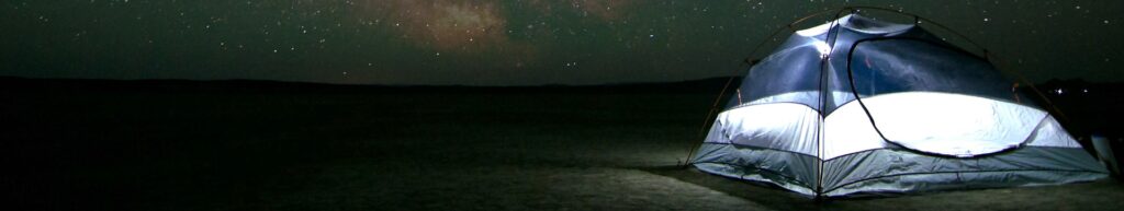 Límite del universo. Una casa de campaña y un cielo lleno de estrellas.