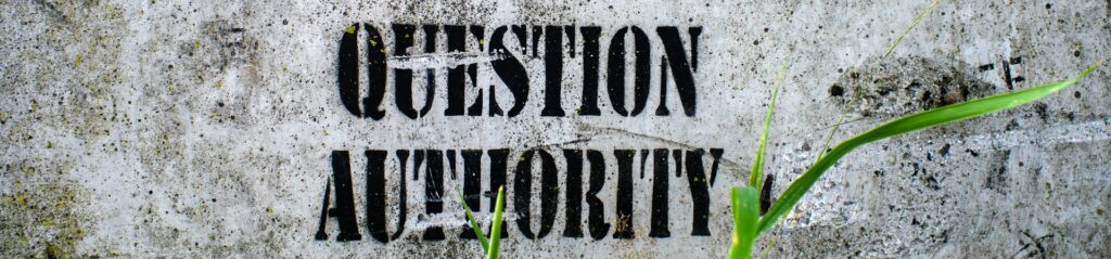 Question authority, a sign that is on the side of a wall