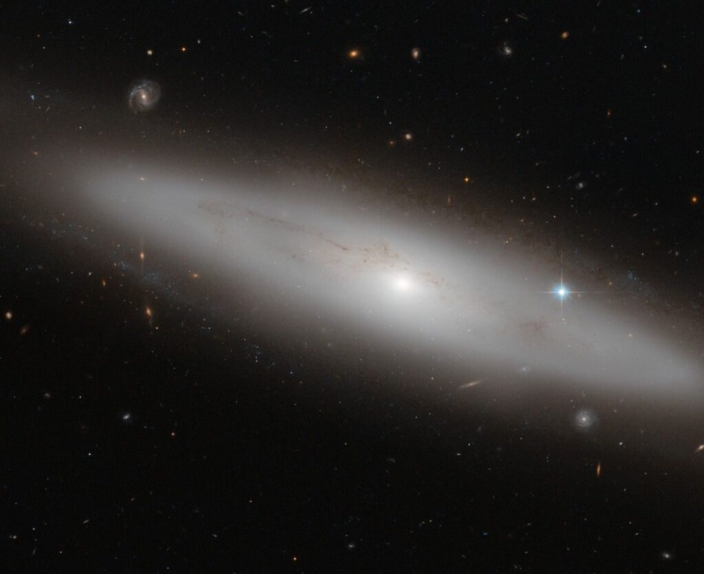 Lenticular galaxies are a kind of cross between spirals and ellipticals. They have the central bulge and disk common to spiral galaxies but no arms. But like ellipticals, lenticular galaxies have older stellar populations and little ongoing star formation.