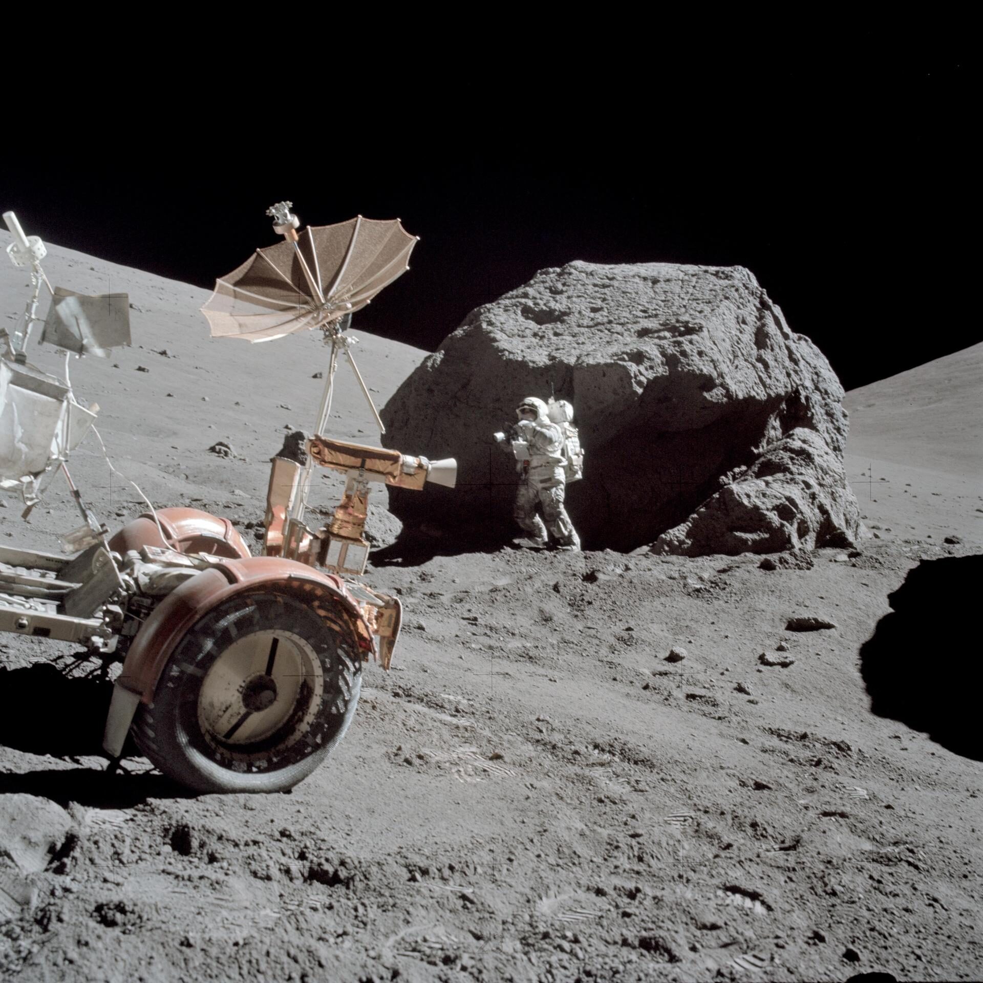AS17-146-22294 (13 Dec. 1972) --- Scientist-astronaut Harrison H. Schmitt is photographed working beside a huge boulder at Station 6 (base of North Massif) during the third Apollo 17 extravehicular activity (EVA) at the Taurus-Littrow landing site. The front portion of the Lunar Roving Vehicle (LRV) is visible on the left. This picture was taken by astronaut Eugene A. Cernan, Apollo 17 commander. Schmitt is the lunar module pilot. While astronauts Cernan and Schmitt descended in the Lunar Module (LM) "Challenger" to explore the moon, astronaut Ronald E. Evans, command module pilot, remained with the Apollo 17 Command and Service Modules (CSM) in lunar orbit.
